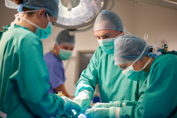 male and female surgeon operating