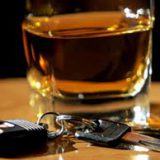 car keys sitting next to a glass of whiskey