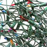 tangled multicolor Christmas lights on a white background