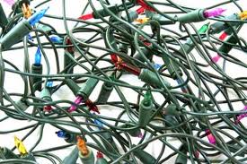 tangled multicolor Christmas lights on a white background